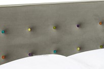 Grey fabric bed frames with coloured buttons