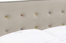 Beige fabric bed frames with coloured buttons