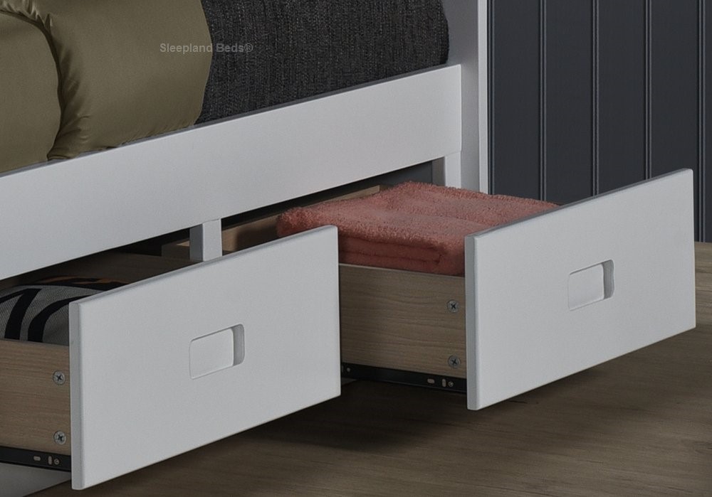 Storage drawers within the white solid wood beds